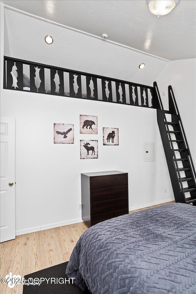 bedroom with baseboards, recessed lighting, and wood finished floors