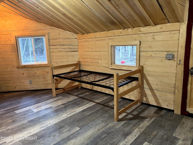 unfurnished bedroom featuring lofted ceiling, wooden ceiling, dark wood-style flooring, multiple windows, and wood walls