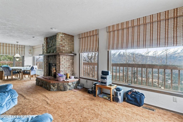 23675 Glacier View Dr, Eagle River, AK 99577 - living room featuring carpet floors, plenty of natural light, a textured ceiling, and visible vents