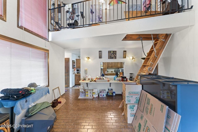 23675 Glacier View Dr, Eagle River, AK 99577 - interior space featuring a towering ceiling, brick floor, and stairs