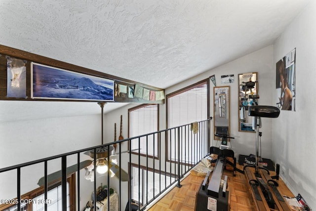 23675 Glacier View Dr, Eagle River, AK 99577 - hallway with baseboards, a textured ceiling, and lofted ceiling