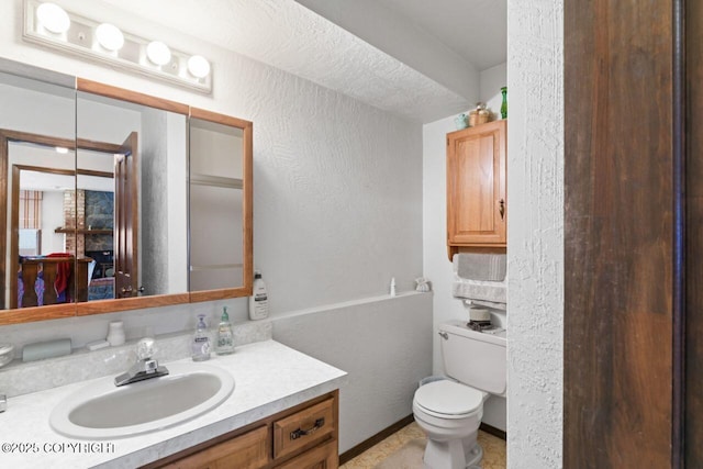 23675 Glacier View Dr, Eagle River, AK 99577 - bathroom with vanity, a textured wall, and toilet