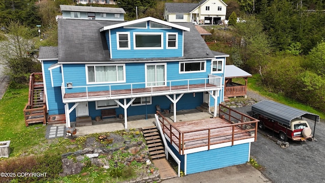 430 Washington St, Ketchikan, AK 99901 - back of property featuring a shingled roof, a wooden deck, and stairway