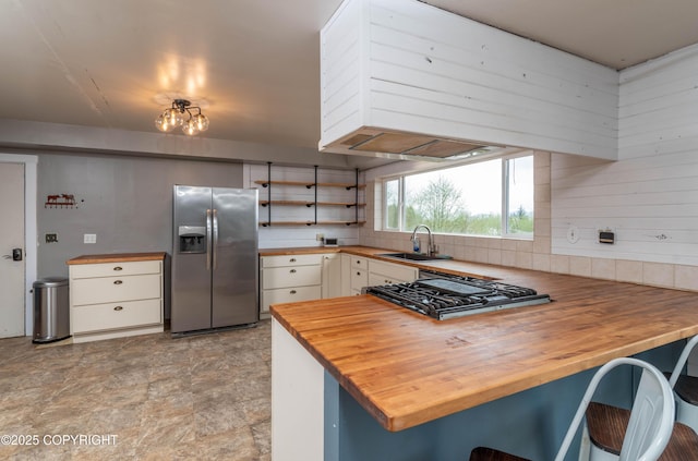430 Washington St, Ketchikan, AK 99901 - kitchen featuring open shelves, a sink, a peninsula, stainless steel refrigerator with ice dispenser, and butcher block counters