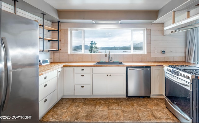 430 Washington St, Ketchikan, AK 99901 - kitchen with a sink, stainless steel appliances, butcher block counters, and a healthy amount of sunlight