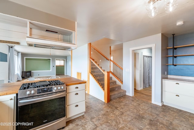 430 Washington St, Ketchikan, AK 99901 - kitchen featuring open shelves, butcher block counters, baseboards, gas range, and white cabinets