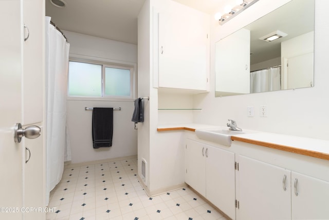 430 Washington St, Ketchikan, AK 99901 - full bathroom with vanity, baseboards, tile patterned floors, and visible vents