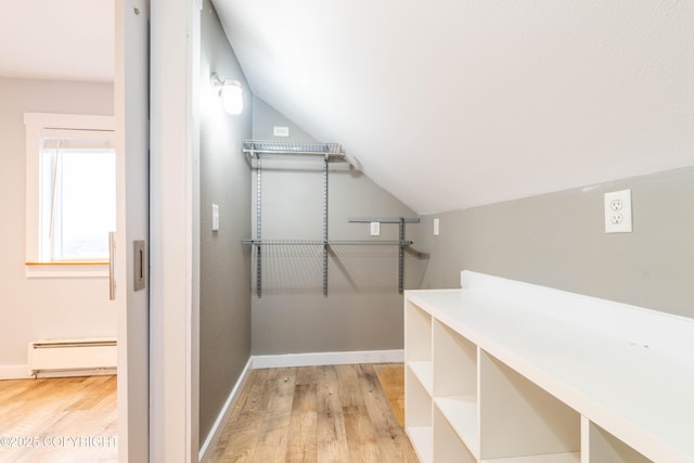 430 Washington St, Ketchikan, AK 99901 - walk in closet with light wood-type flooring, lofted ceiling, and baseboard heating