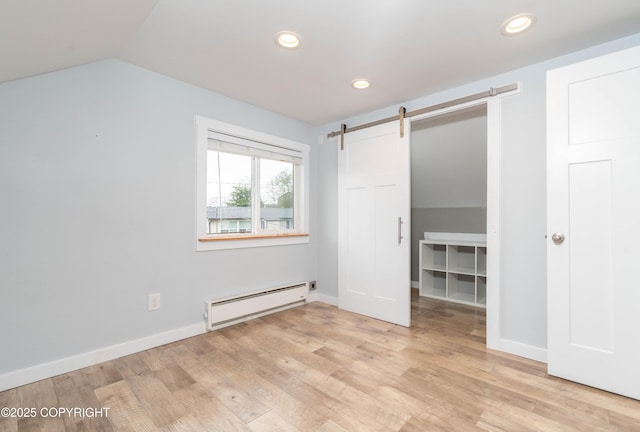 430 Washington St, Ketchikan, AK 99901 - unfurnished bedroom with light wood-style floors, baseboard heating, recessed lighting, and a barn door