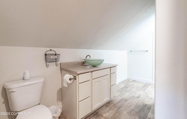 430 Washington St, Ketchikan, AK 99901 - half bathroom featuring wood finished floors, lofted ceiling, toilet, and vanity