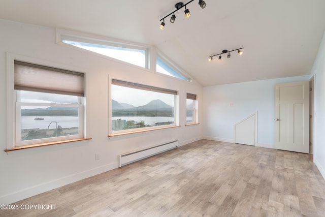 430 Washington St, Ketchikan, AK 99901 - bonus room with baseboards, a baseboard heating unit, light wood finished floors, and lofted ceiling
