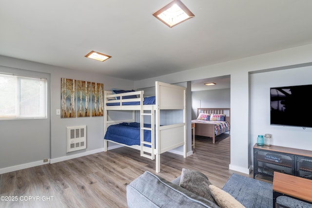 430 Washington St, Ketchikan, AK 99901 - bedroom with heating unit, baseboards, and wood finished floors