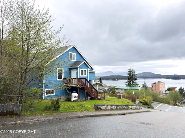 430 Washington St, Ketchikan, AK 99901 - view of front facade featuring fence, stairs, and a water and mountain view