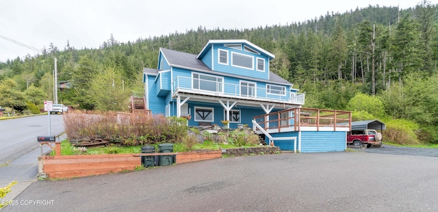 430 Washington St, Ketchikan, AK 99901 - view of front of property featuring stairway, a view of trees, a detached carport, covered porch, and driveway