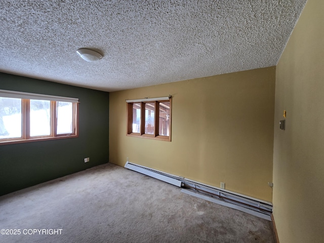 carpeted spare room with plenty of natural light, a baseboard radiator, and a textured ceiling