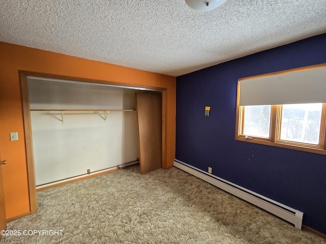 unfurnished bedroom featuring a textured ceiling, baseboards, a baseboard radiator, a closet, and carpet flooring