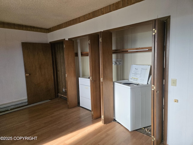 washroom with washer / clothes dryer, a textured ceiling, laundry area, and light wood-type flooring