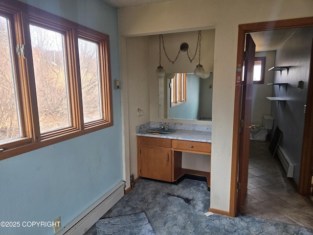 bathroom with vanity, a baseboard radiator, and toilet
