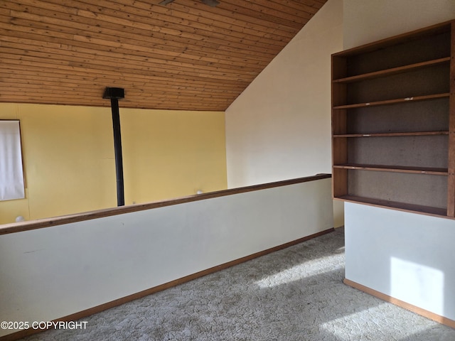unfurnished room with carpet floors, baseboards, vaulted ceiling, and wooden ceiling