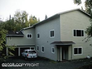 rear view of property featuring aphalt driveway