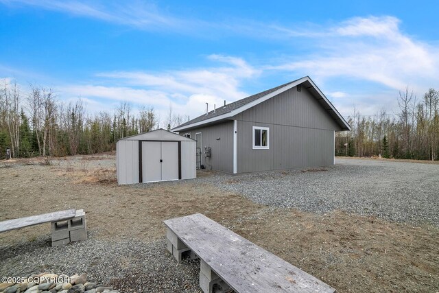 view of side of property with an outbuilding and a shed