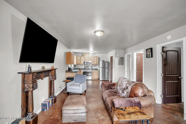 living room with finished concrete floors and baseboards