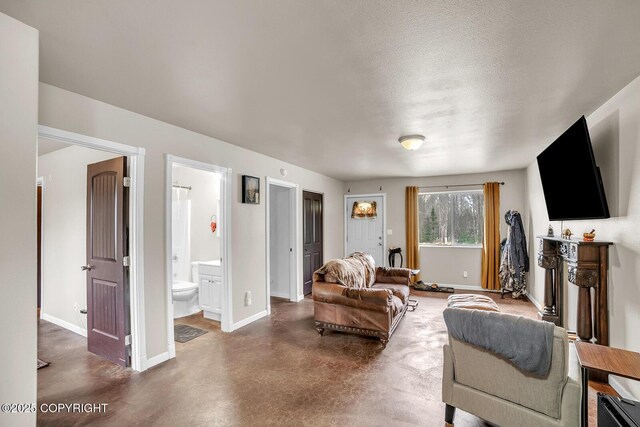living room with baseboards and finished concrete floors