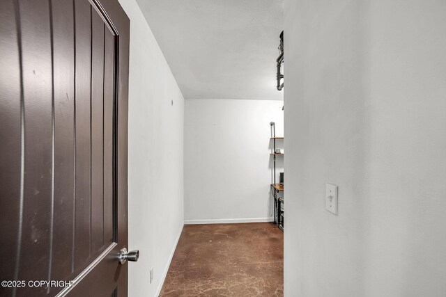 interior space with baseboards and concrete flooring