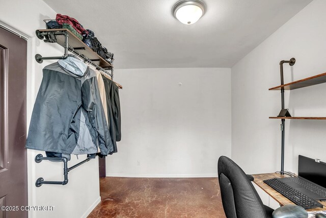 home office with baseboards and concrete floors