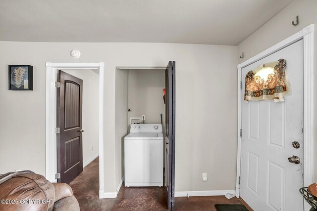 washroom with baseboards, laundry area, and washer / clothes dryer