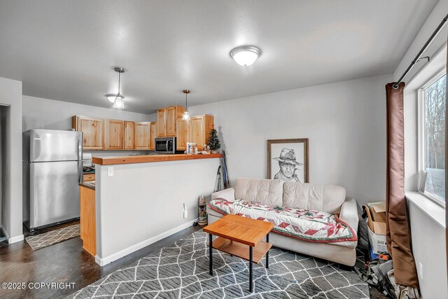 living room with baseboards and concrete floors