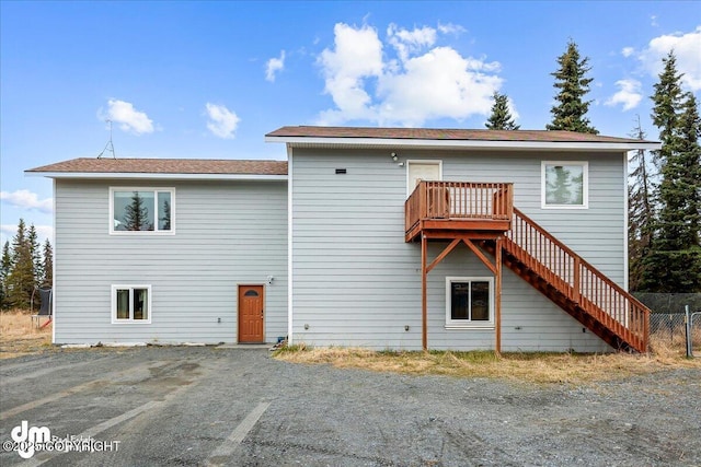 back of property featuring a deck and stairway