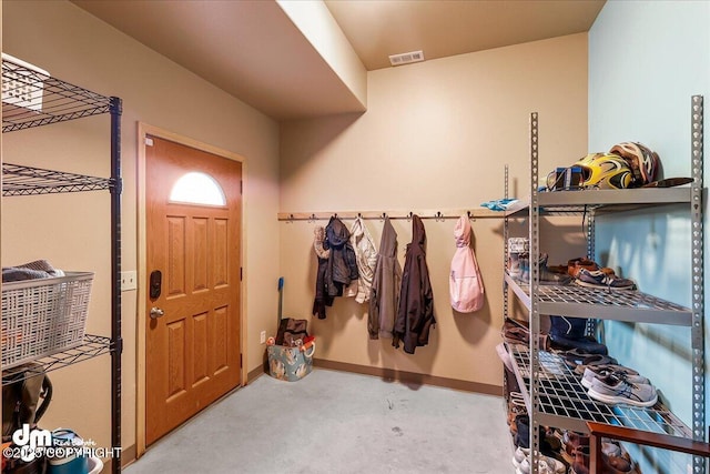mudroom with concrete floors, visible vents, and baseboards