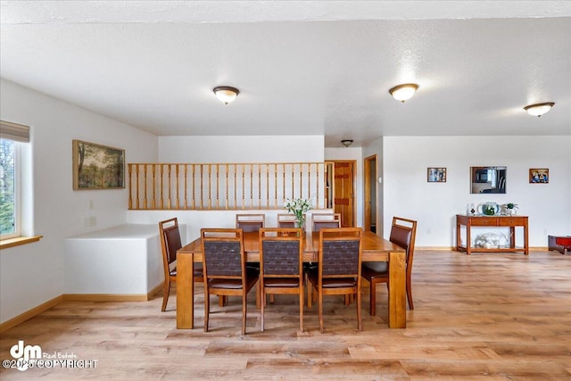 dining room featuring baseboards and wood finished floors