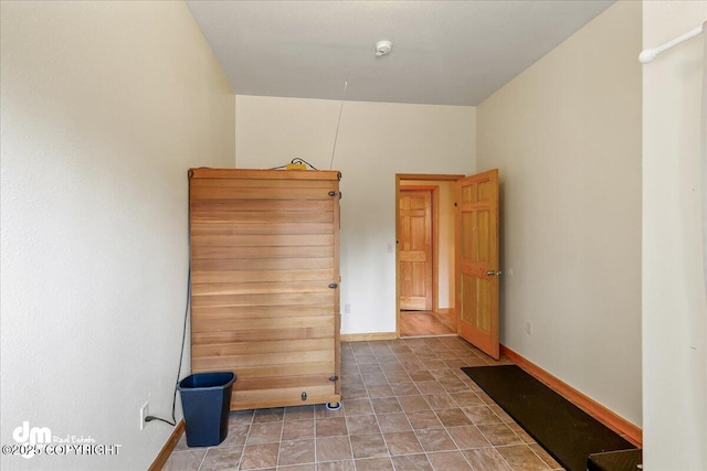 unfurnished room with baseboards