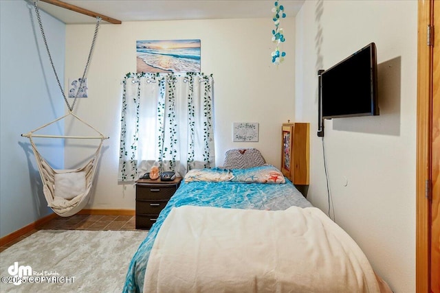 bedroom featuring baseboards and tile patterned floors