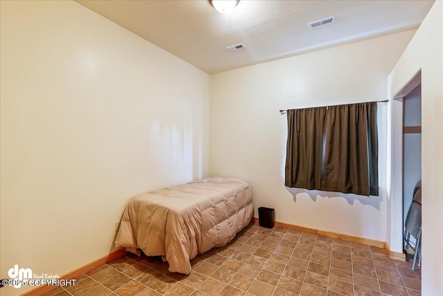 bedroom featuring visible vents and baseboards