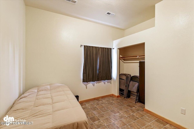 bedroom with baseboards, a closet, and visible vents