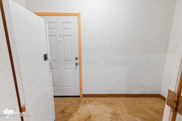 interior space with light carpet and baseboards
