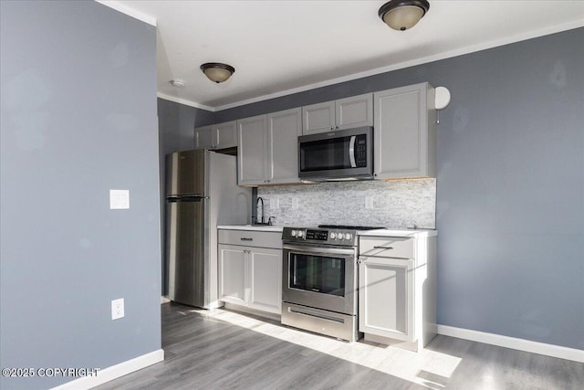 1369 Morning Glory Loop, North Pole, AK 99705 - kitchen featuring stainless steel appliances, backsplash, baseboards, light countertops, and crown molding