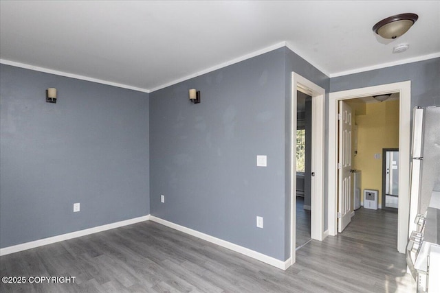 1369 Morning Glory Loop, North Pole, AK 99705 - spare room featuring wood finished floors, a smoke detector, baseboards, and ornamental molding