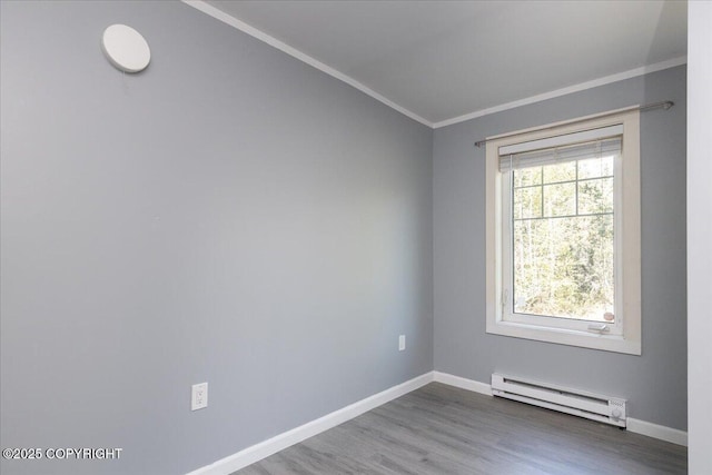 1369 Morning Glory Loop, North Pole, AK 99705 - unfurnished room with a baseboard heating unit, crown molding, wood finished floors, and baseboards