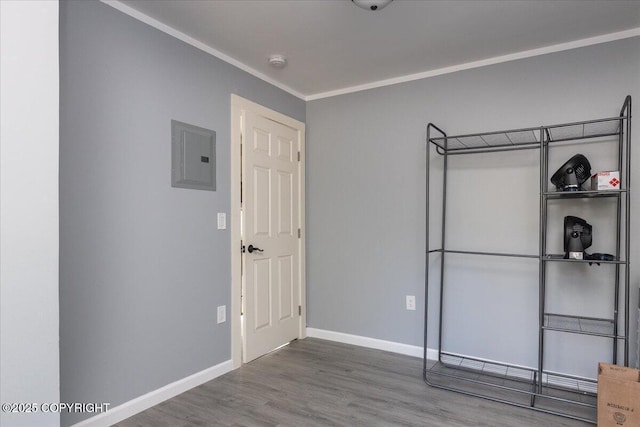 1369 Morning Glory Loop, North Pole, AK 99705 - unfurnished bedroom featuring electric panel, baseboards, wood finished floors, and ornamental molding