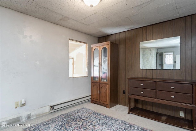 869 Bouton Ct, Fairbanks, AK 99712 - foyer entrance featuring a baseboard heating unit, wood walls, and light colored carpet