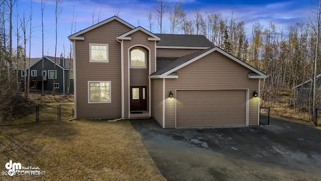 7865 S Settlers Bay Dr, Wasilla, AK 99623 - view of front facade with a garage, fence, a gate, and driveway