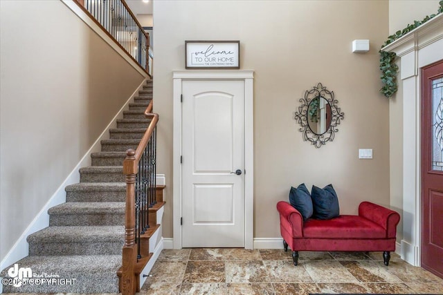 7865 S Settlers Bay Dr, Wasilla, AK 99623 - entryway featuring baseboards, stone finish floor, and stairs