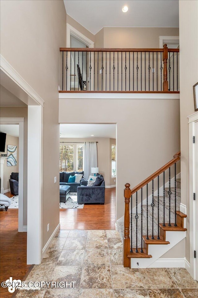 7865 S Settlers Bay Dr, Wasilla, AK 99623 - entryway featuring baseboards, stairs, wood finished floors, and a towering ceiling