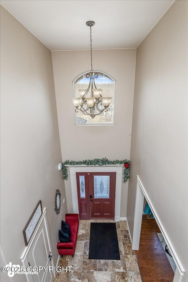 7865 S Settlers Bay Dr, Wasilla, AK 99623 - entrance foyer featuring baseboards, visible vents, and a chandelier