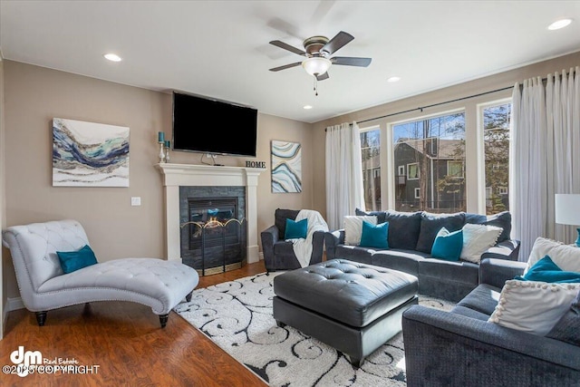7865 S Settlers Bay Dr, Wasilla, AK 99623 - living room with a ceiling fan, wood finished floors, baseboards, a glass covered fireplace, and recessed lighting
