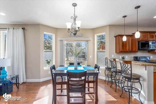7865 S Settlers Bay Dr, Wasilla, AK 99623 - dining room featuring baseboards, wood finished floors, and an inviting chandelier